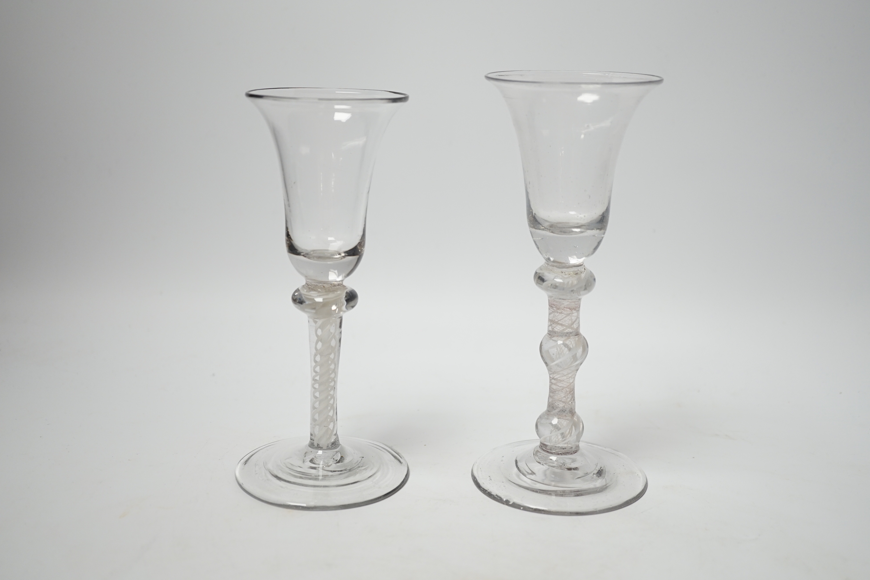 Two Dutch DSOT stem glasses, with bell-shaped bowls, one with three knops, the other with one knop at the top of the stem, tallest 17cm